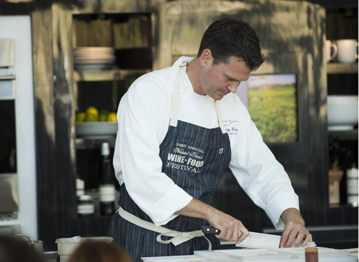 Chef Craig Strong in a cooking demonstration at the Newport Beach Wine & Food Festival. Credit: Pencilbox Studios