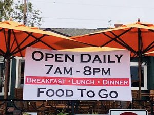 Sign at Laguna Beach restaurant showing takeout only menu